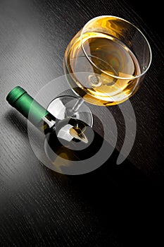 Top of view of white wine glass near bottle