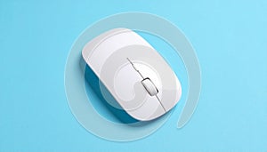 Top View of a White Wireless Computer Mouse on a Blue Surface wireless mouse technology