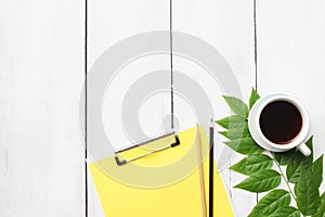 Top view white wooden desk table with coffee cup, pencil and file and have copy space.