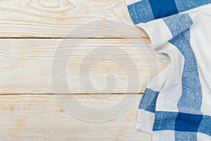 Top view on a white wooden table with a linen kitchen towel or textile napkin. a tablecloth on a light wood countertop