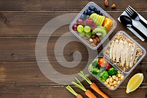 Wholesome nutrient rich food set in take away boxes on wood table background with copy space photo