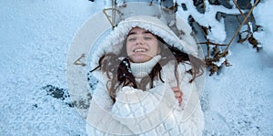 Top view wide banner panorama portrait of attractive, young, sexy, brunette woman, lying or standing on a icy hoarfrost frozen