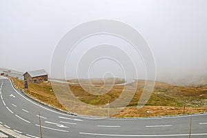 Top view of a winding mountain road in fog