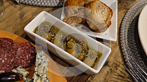 Top view of wine appetizers; cheese, salami,, toast bread and green olives