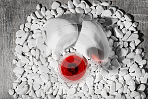 Top view of a wine glass. Red bordeaux in a glass on a gray background. Alcoholic wine on white rocks. Winery concept.