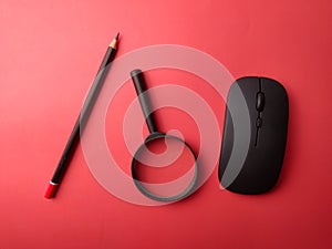 Top view wireless mouse, pencil and magnifying glass