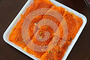 Top view wof Knafeh traditional Middle Eastern dessert food on disposable dish