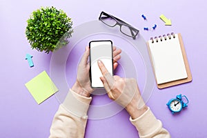 Top view of woman hands holding smart phone with blank copy space screen for your text message or information content