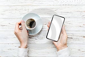 Top view of woman hands holding smart phone with blank copy space screen for your text message or information content