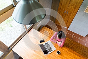 Top view of woman looking at the laptop computer