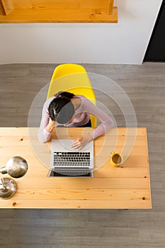 Top view of woman looking at the laptop computer