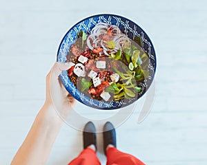 Top view of woman photographing healthy breakfast bowl