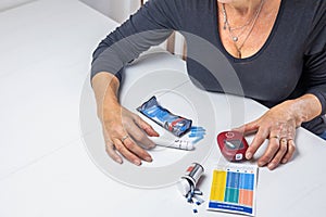 Top view of woman preparing device for measuring blood sugar