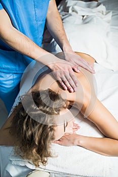 Top view of woman receiving back massage at spa. Female having relaxing massage on her back in spa. photo