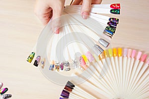 Top view woman selects color shellac nail polish.