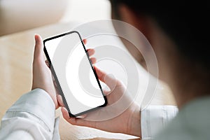 Top view Woman sitting and holding blank screen mock up mobile phone