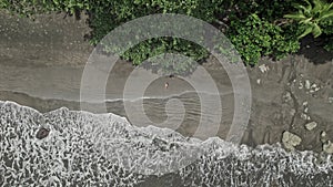 Top view of a woman sunbathing in a wild beach