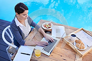 Top view of woman, typing on laptop and remote work, planning day for schedule or agenda with breakfast outdoor