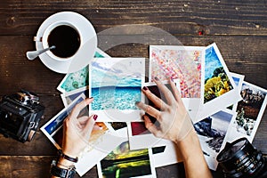 Top view of women`s hands holding printed photos