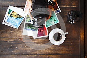 Top view of women`s hands holding printed photos