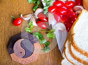 Top-view of a wood table with olives tomatoes bread