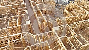 Top view of wooden apartment building under construction in new developing suburban area. Development of residential
