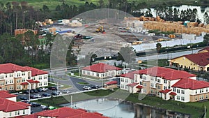 Top view of wooden apartment building under construction in new developing suburban area. Development of residential