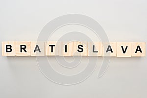 Top view of wooden blocks with Bratislava lettering on grey background.