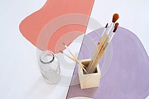 Top view of wooden box container holder with paintbrushes on desk, natural decor concept.