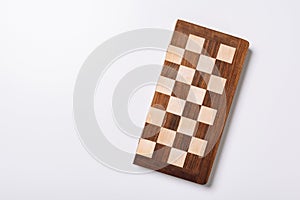 Top view of wooden checkerboard on white background