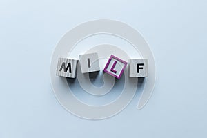 top view of wooden cubes with word Milf
