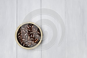 Top view wooden cup, put the red beans on a wooden plate