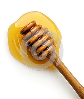 Top view of wooden honey dripper in the honey puddle photo