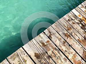 Top view of a wooden jetty walk on background of lagoon waters