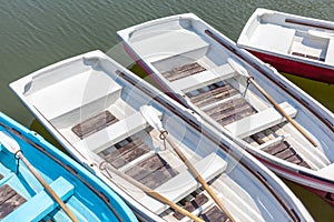 Top view of wooden rowboats floating around the dock.