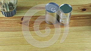 Top view on wooden table served with empty blender chalice and steel cans