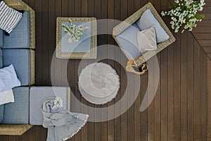 Top view of wooden terrace with comfortable wicker furniture