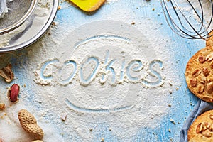 Top view of word Cookie written on flour and product set for cooking cookies