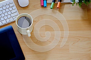 Top view work desk. Mock up Office desk table with computer, supplies and coffee cup.