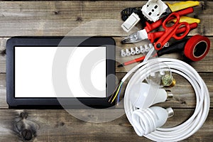 Top view of work tools and electrical system components on wooden background