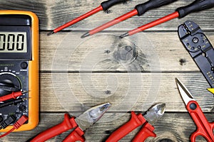 Top view of work tools for residential electrical installation on antique wooden background.