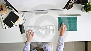 Top view worker working on workspace, Man using computer above shot.