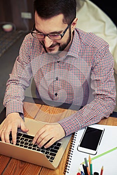 Top view of a working businessman who typing on his laptop