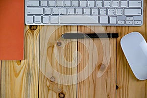 top view of working desk table with keyboard, mouse, notebook