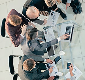 top view. working group discussing financial reports at an office meeting .
