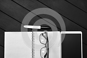 Top view of working space with white paper for text in wood clipboard pen and blank screen smart phone on wooden table with copy