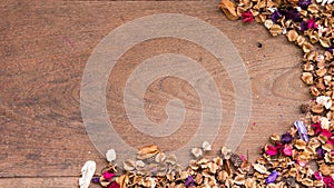 Top view workspace with dried flowers on wooden table background