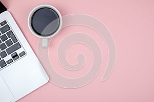 Top view of workspace with laptop, cup of coffee and copy space