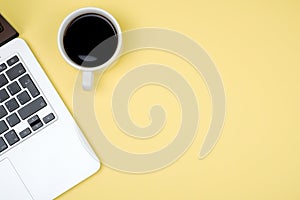 Top view of workspace with laptop, cup of coffee and copy space