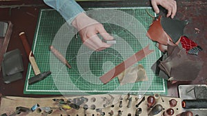 Top view of worktop in leather workshop with different tools